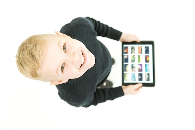 The happy boy stand with a laptop. View from above