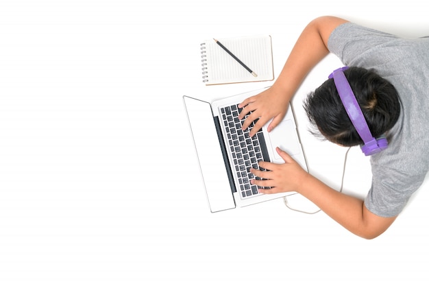 Happy boy student playing computer with headsets and enjoy online learning