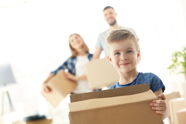 Happy boy with box on blurred. Moving concept