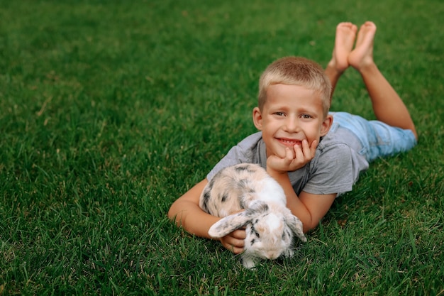 A happy boy with a lop-eared rabbit