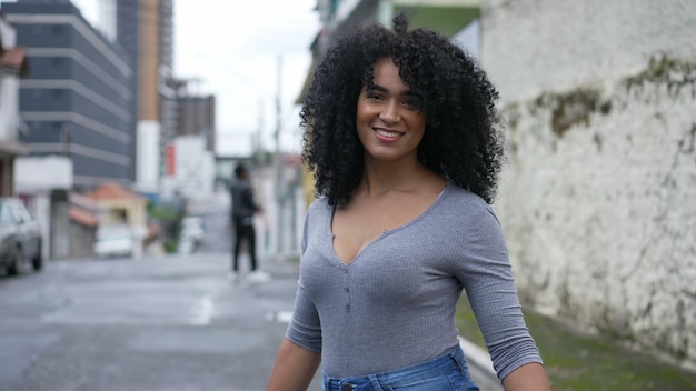 A happy Brazilian woman turning towards camera smiling