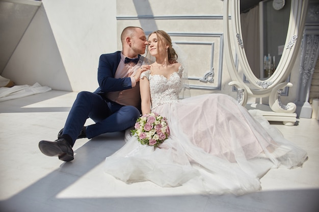 Happy bride and groom hugging and kissing, love