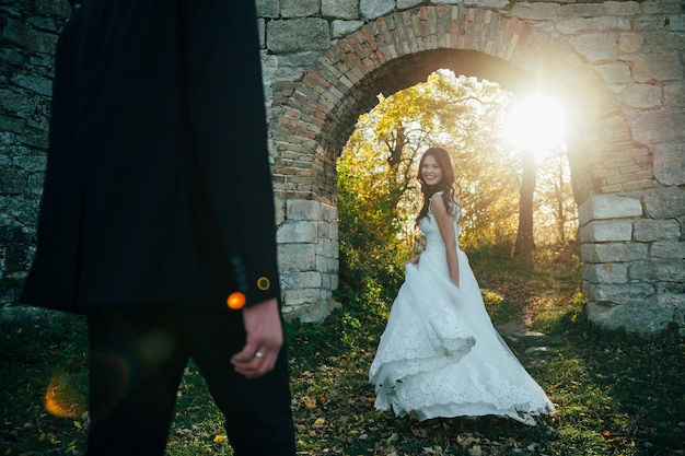 happy bride and groom near the medieval palace on their wedding day