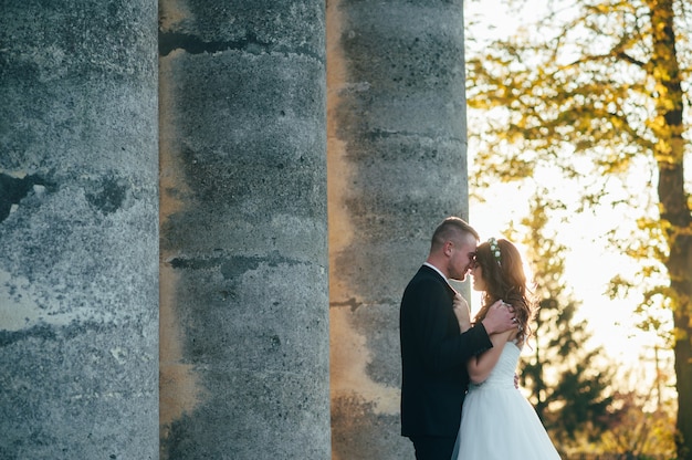 happy bride and groom near the medieval palace on their wedding day