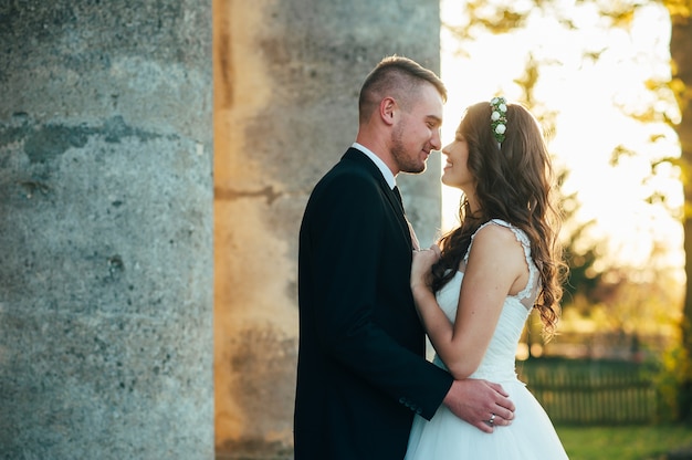 happy bride and groom near the medieval palace on their wedding day