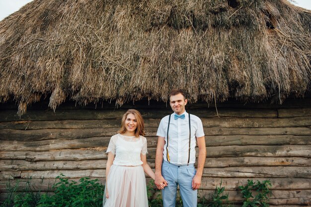 Happy Bride and groom walking on the green grass