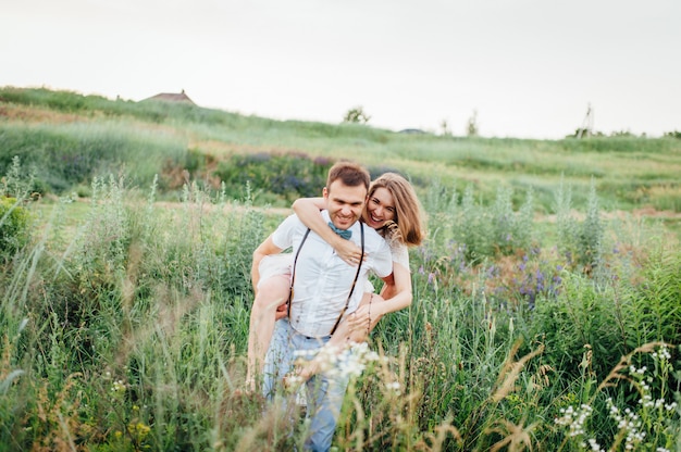 Happy Bride and groom walking on the green grass