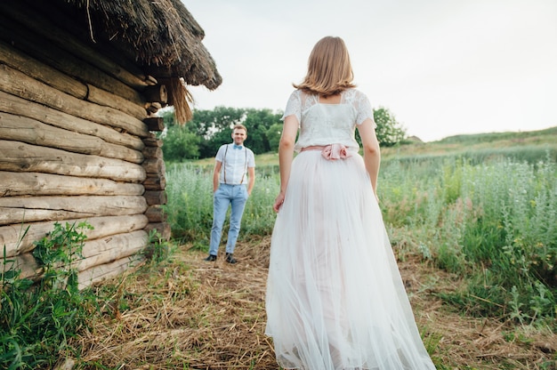 Happy Bride and groom walking on the green grass