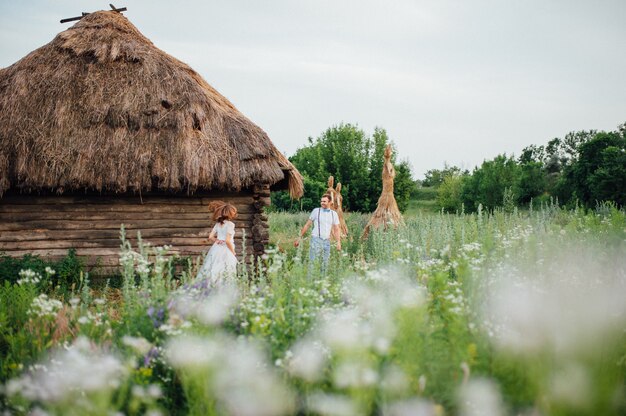 Happy Bride and groom walking on the green grass