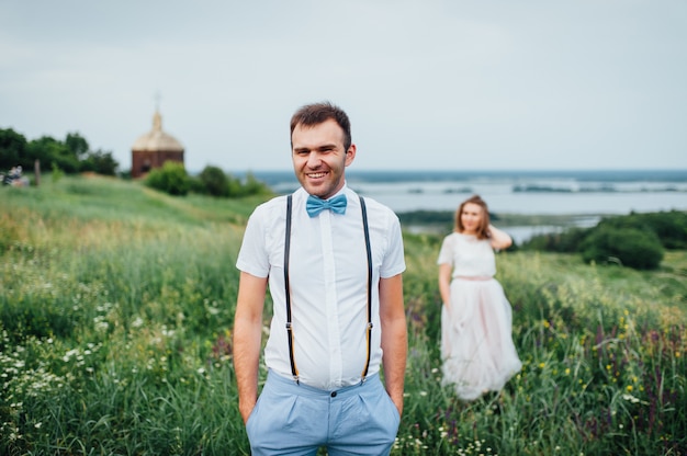 Happy Bride and groom walking on the green grass