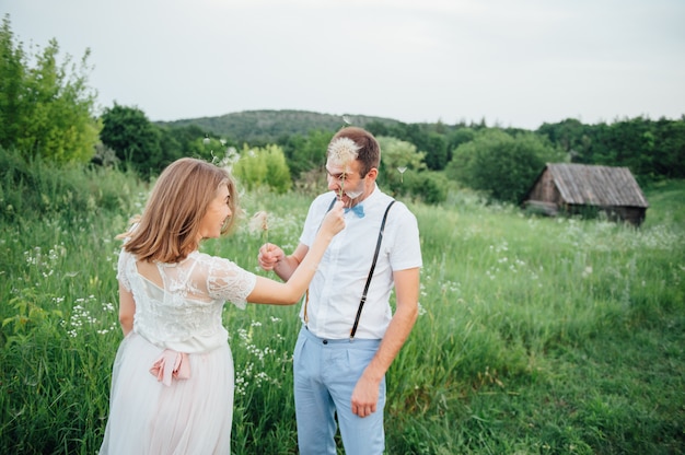 Happy Bride and groom walking on the green grass