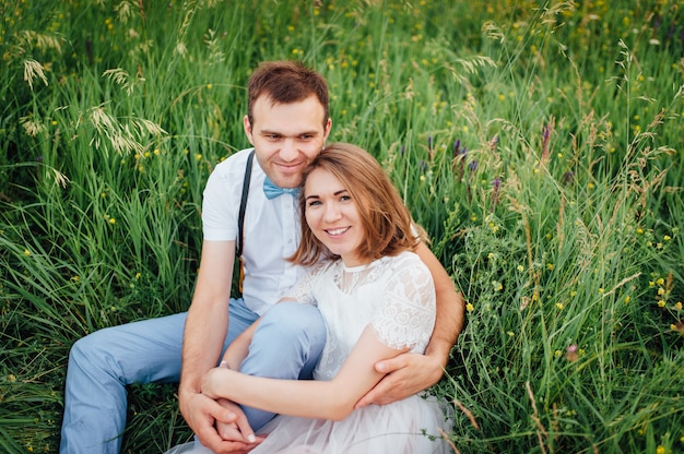 Happy Bride and groom walking on the green grass