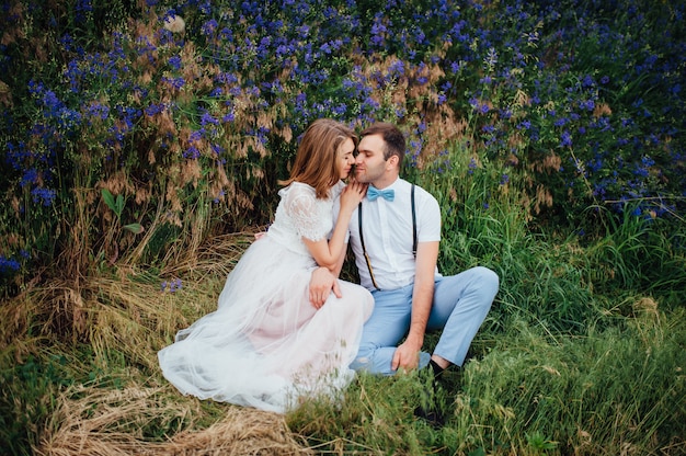 Happy Bride and groom walking on the green grass