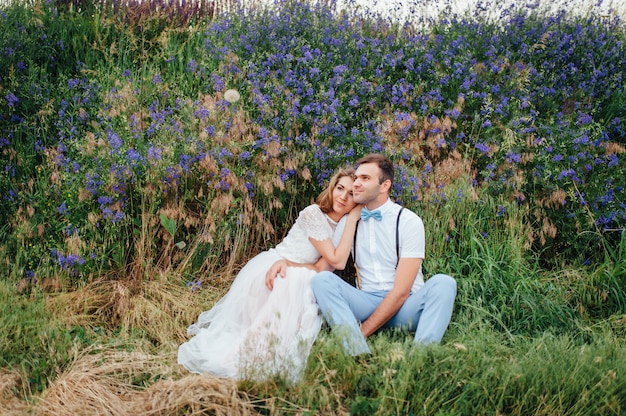 Happy Bride and groom walking on the green grass