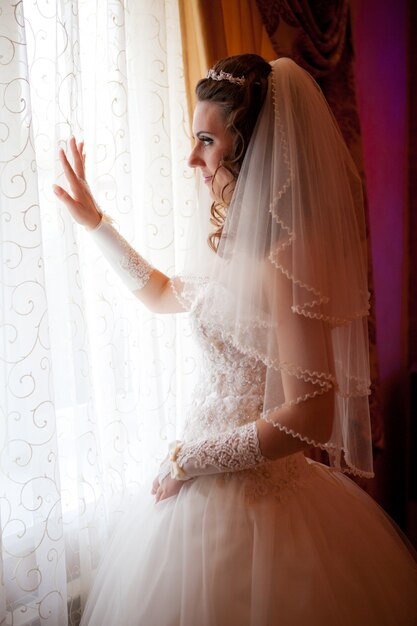 Happy bride looking in window