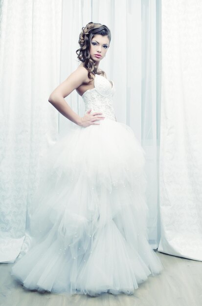 Happy bride posing in hotel room