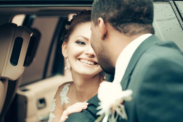 Happy bride smiles to groom