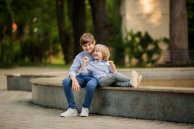 happy brothers in the park in the summer evening