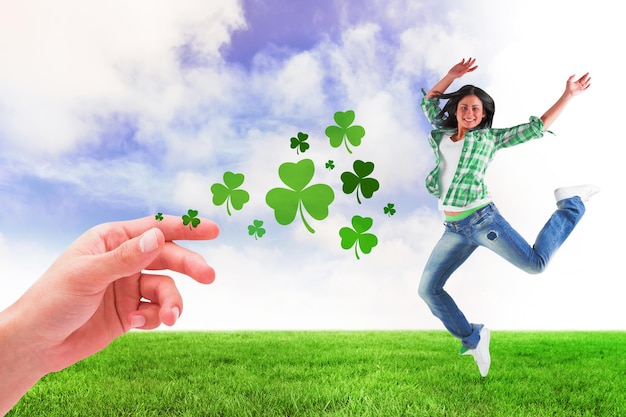 Happy brunette against green field