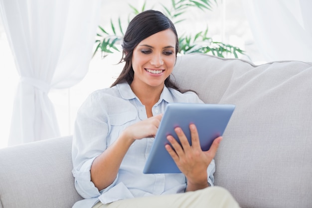 Happy brunette with tablet pc