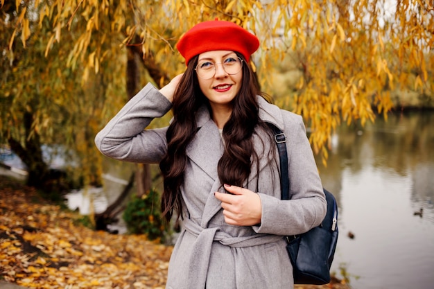 Happy brunette woman in stylish red beret