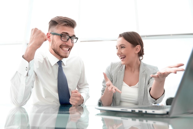 Happy business couple sitting at Desk