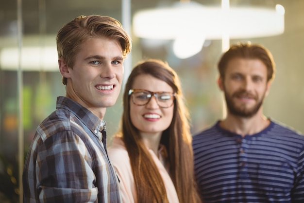 Happy business executives standing in office