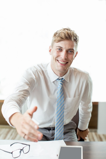 Happy Business Man Extending Arm for Handshake