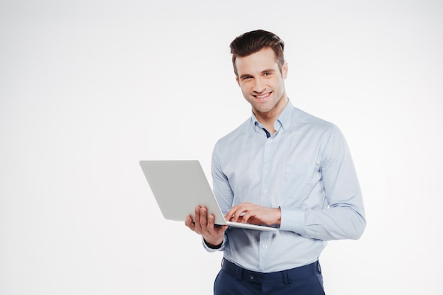 Happy business man holding laptop