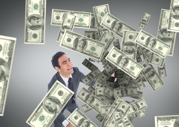 happy business man looking at money rain against grey background