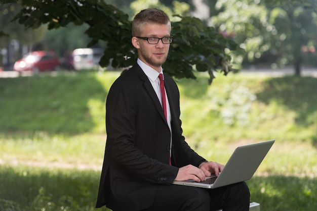 Happy Business Man Using Tablet Pc Outside On A Park Bench