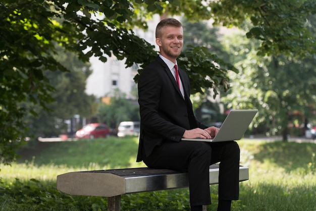 Happy Business Man Using Tablet Pc Outside On A Park Bench