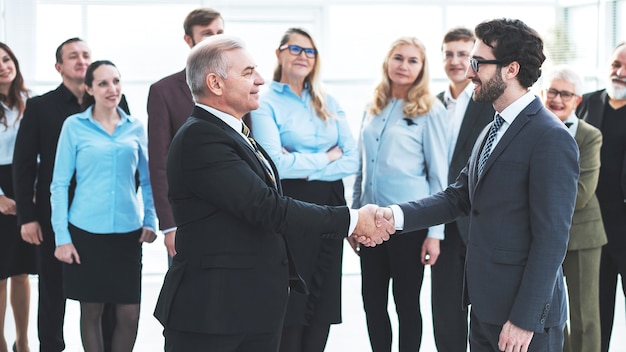 Happy business partners shaking hands