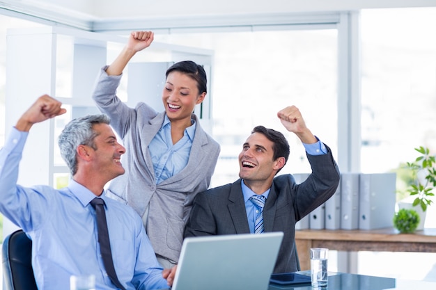 Happy business people cheering together 