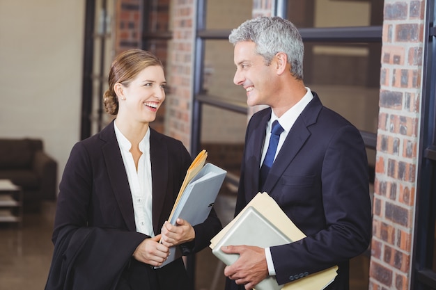 Happy business people discussing at office