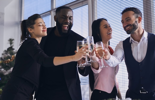 The happy business people drinking champagne