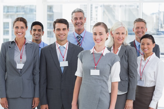 Happy business people looking at camera in office 