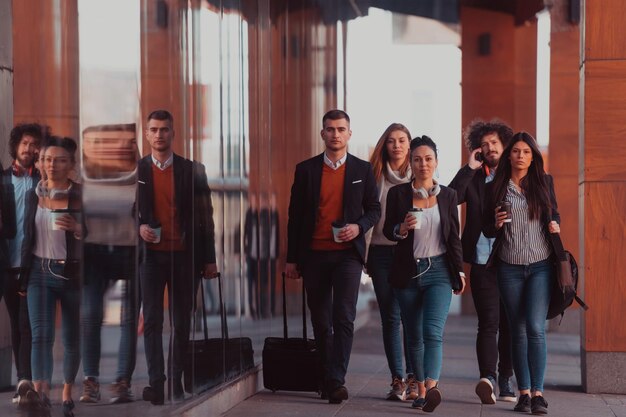 Happy business people walking in the street after a successful
day of work and discussing the closed deals. high-quality
photo