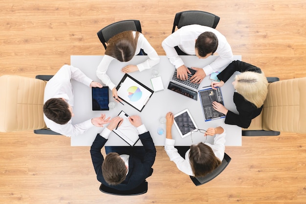 The happy business people work at the desktop. view from above