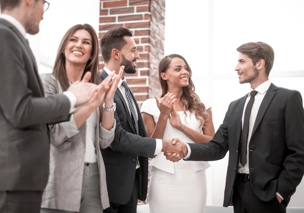 Happy business team applauds new business partners