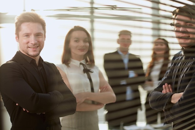 Happy business team is standing in the office applauding