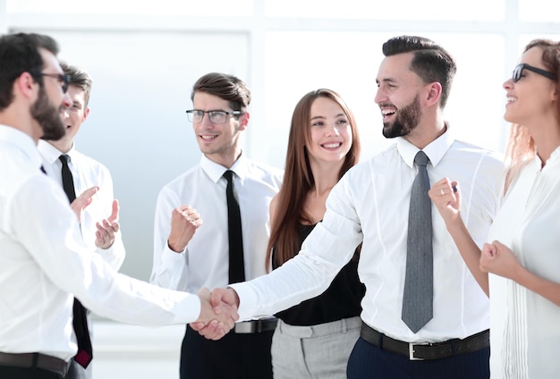 Happy business team looking for a handshake of business partners