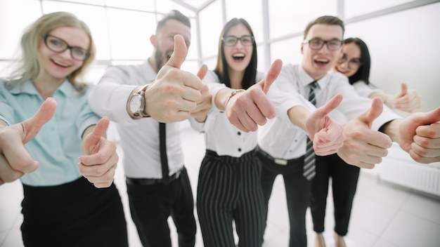 happy business team showing thumbs up.