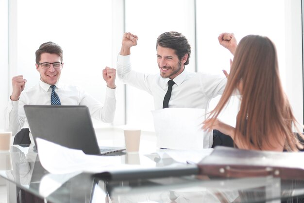 Happy business team sitting at the Desk