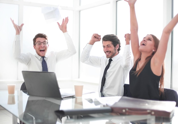 Happy business team sitting at the Desk