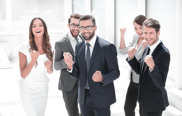 Happy business team standing in office