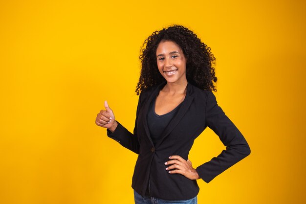 Happy business woman giving thumbs up