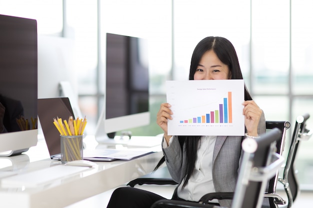 Happy business woman in office.