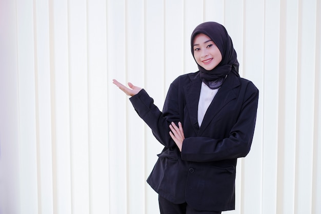 Happy business woman showing something