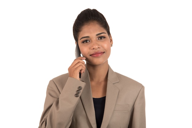 Happy business woman talking on the mobile phone or smartphone isolated on white background